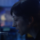 A woman talking into a microphone.